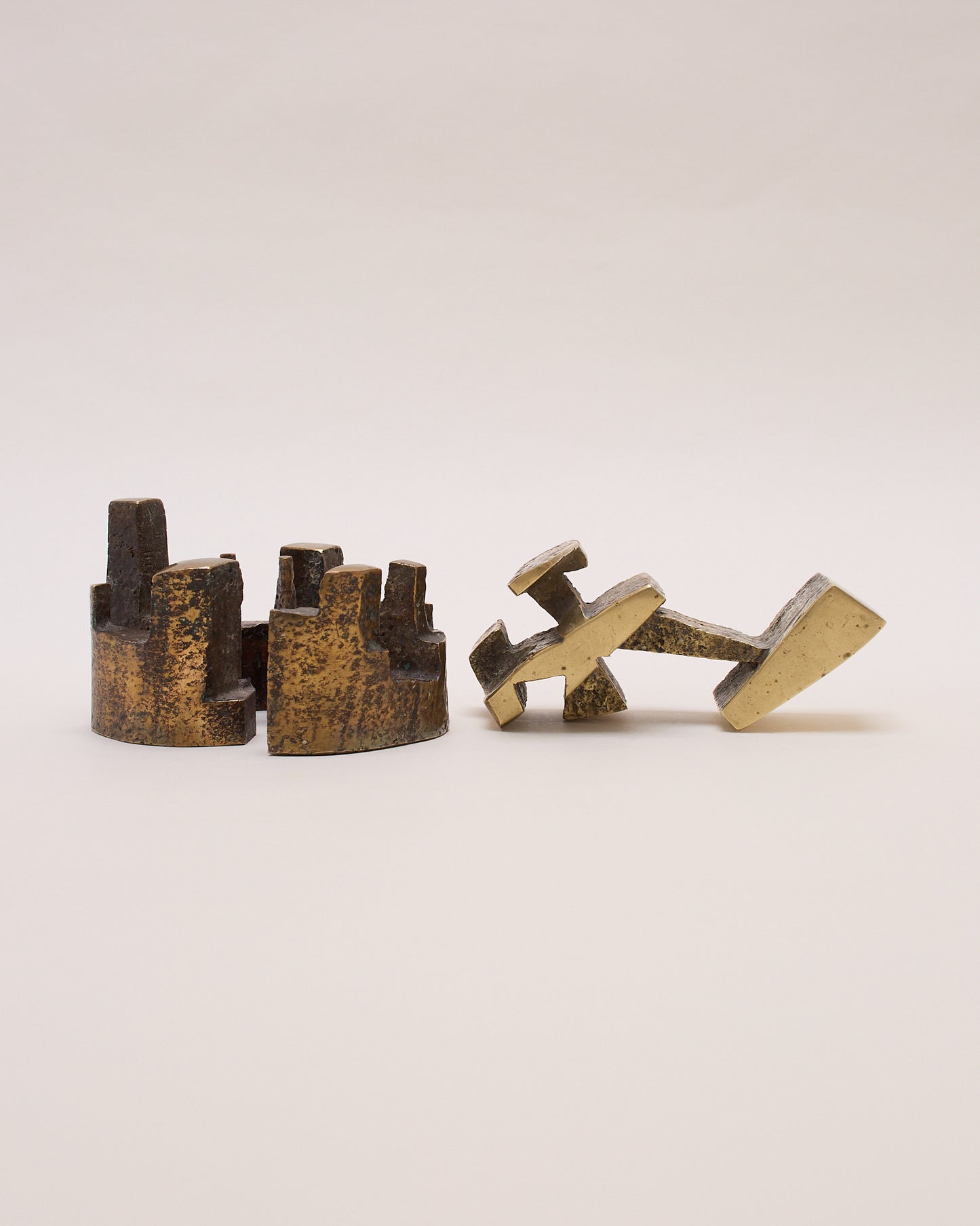 Side-by-side bronze parts of sculpture by Christian Lymann Hansen (c.1970) — two geometric geometric forms.