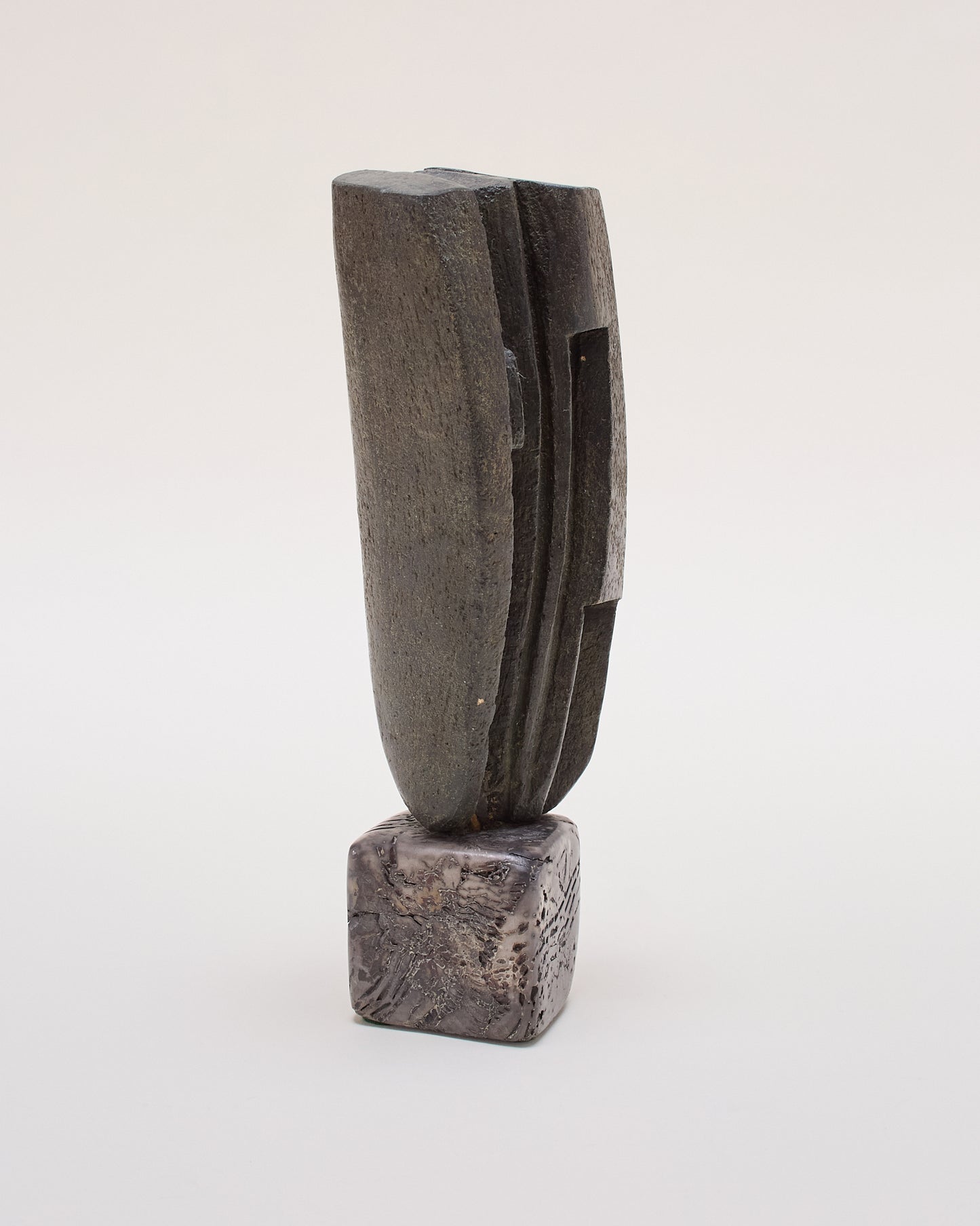 Side view of Peter Hayes sculpture — textured surface and carved detail.