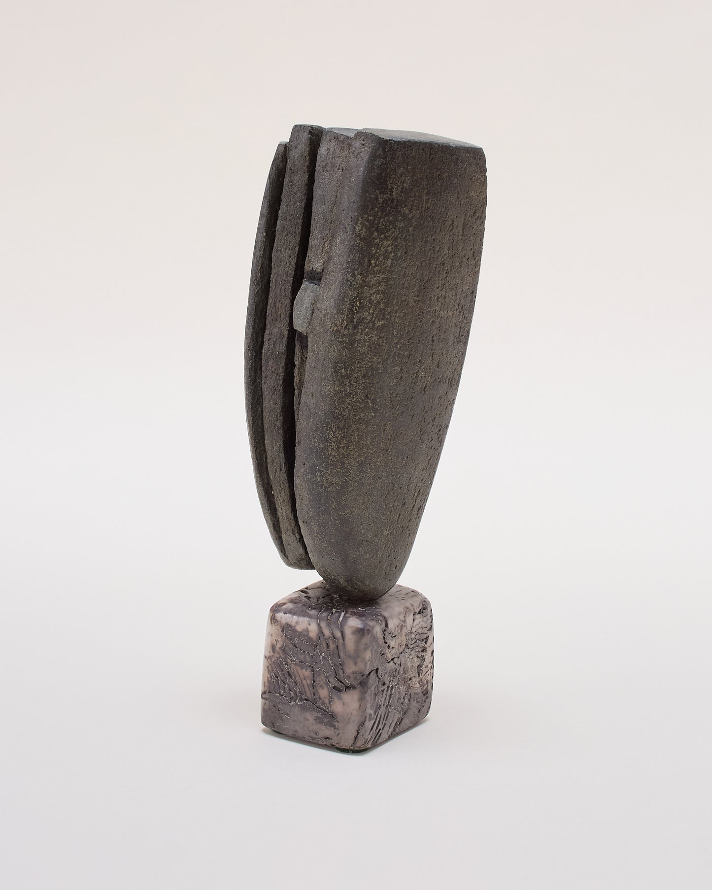 Reverse angle showing Peter Hayes sculpture — slate-grey with raku base.
