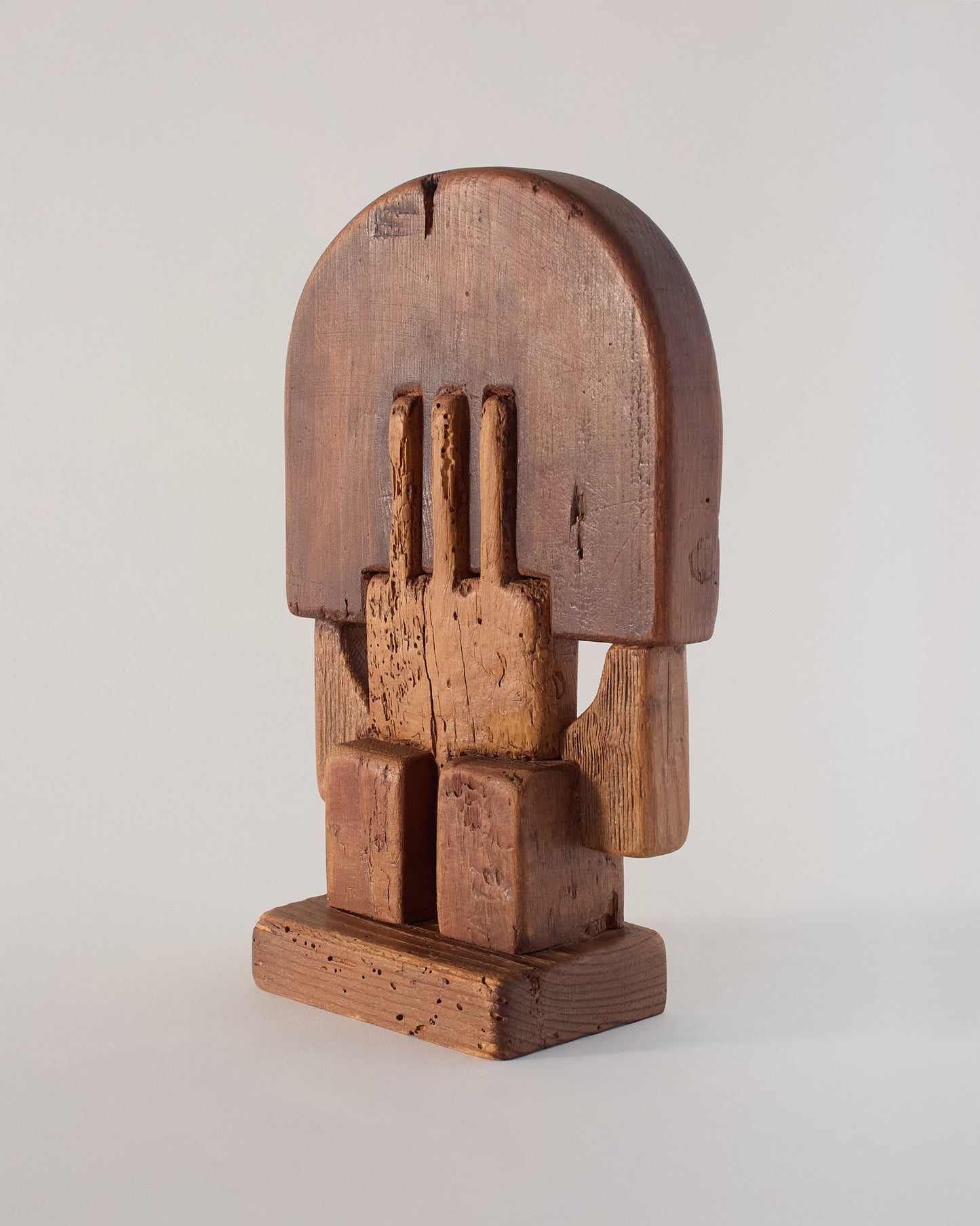 Side view of Adolf Vallazza sculpture (1977) — carved wooden forms showing original grain, cracks, and marks.