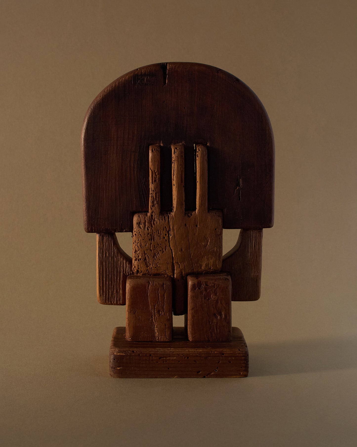 Wooden sculpture by Adolf Vallazza (1977) — interlocking abstract forms carved from salvaged wood.