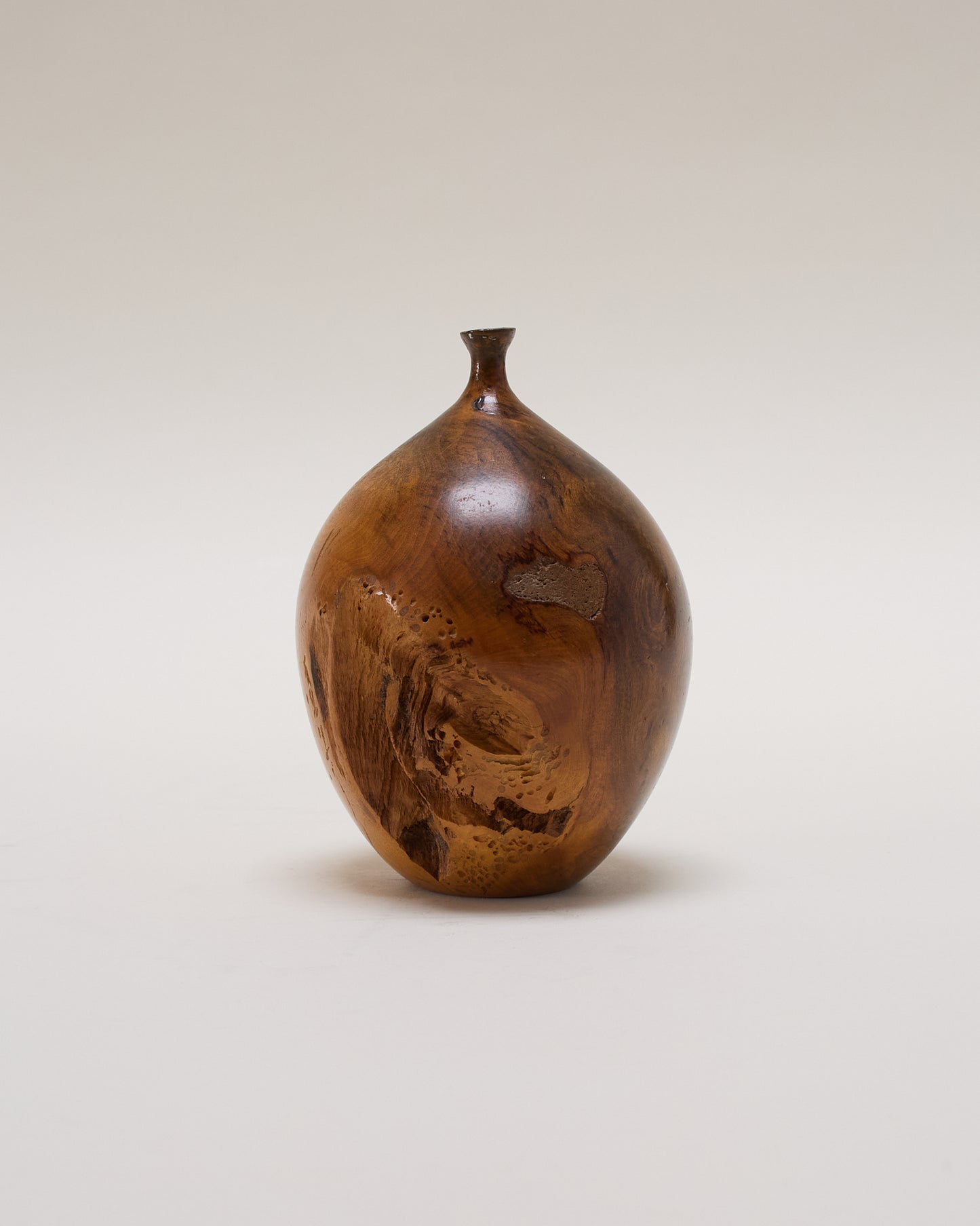 Wooden vase by Hap Sakwa (1980) — hand-turned Buckeye root with natural grain and sculptural form.