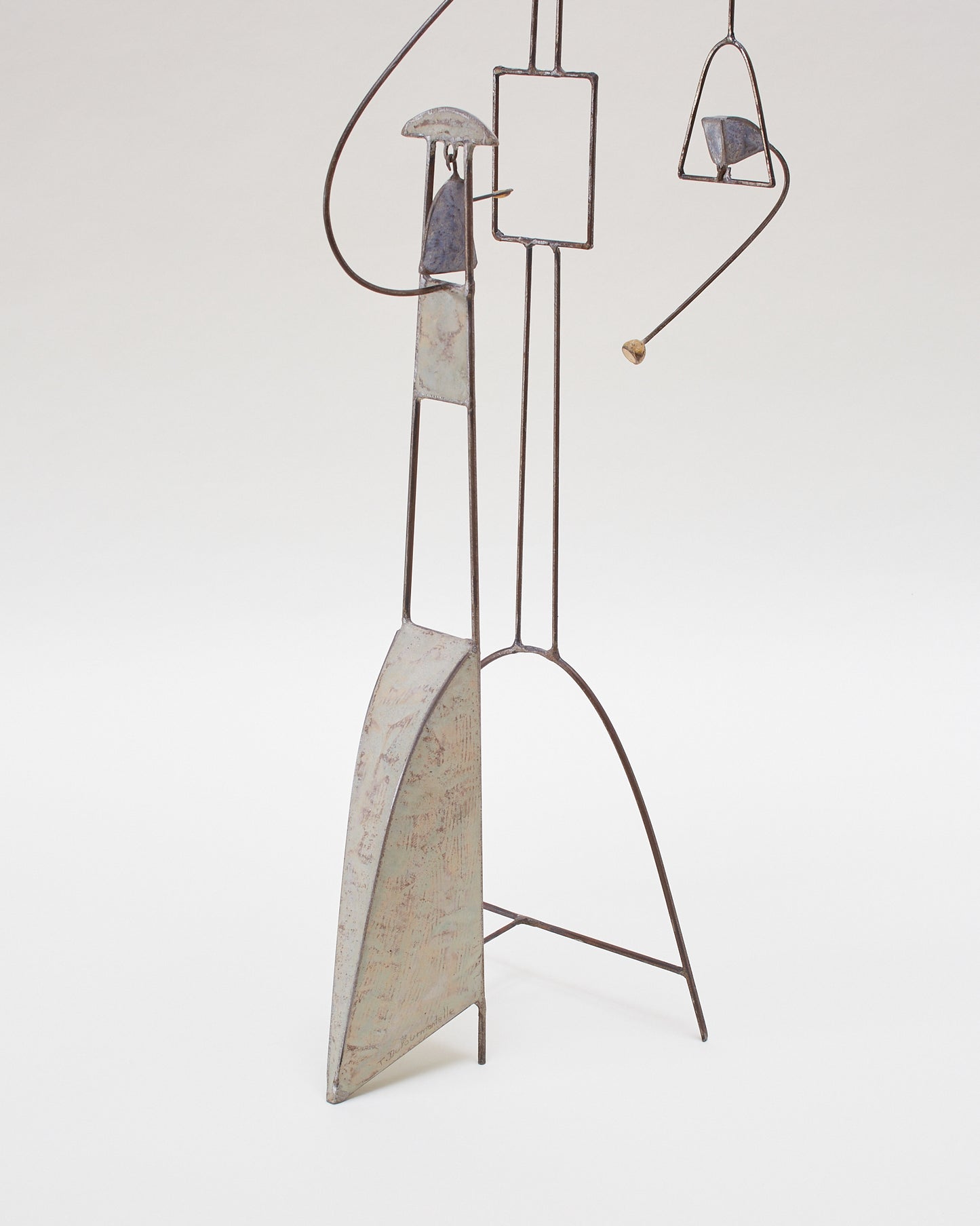 Bottom detail view of the kinetic abstract sculpture (20th century) by Thierry Dufourmantelle, featuring four moving parts, constructed from steel and concrete with pastel yellow, turquoise, and blue pigments.