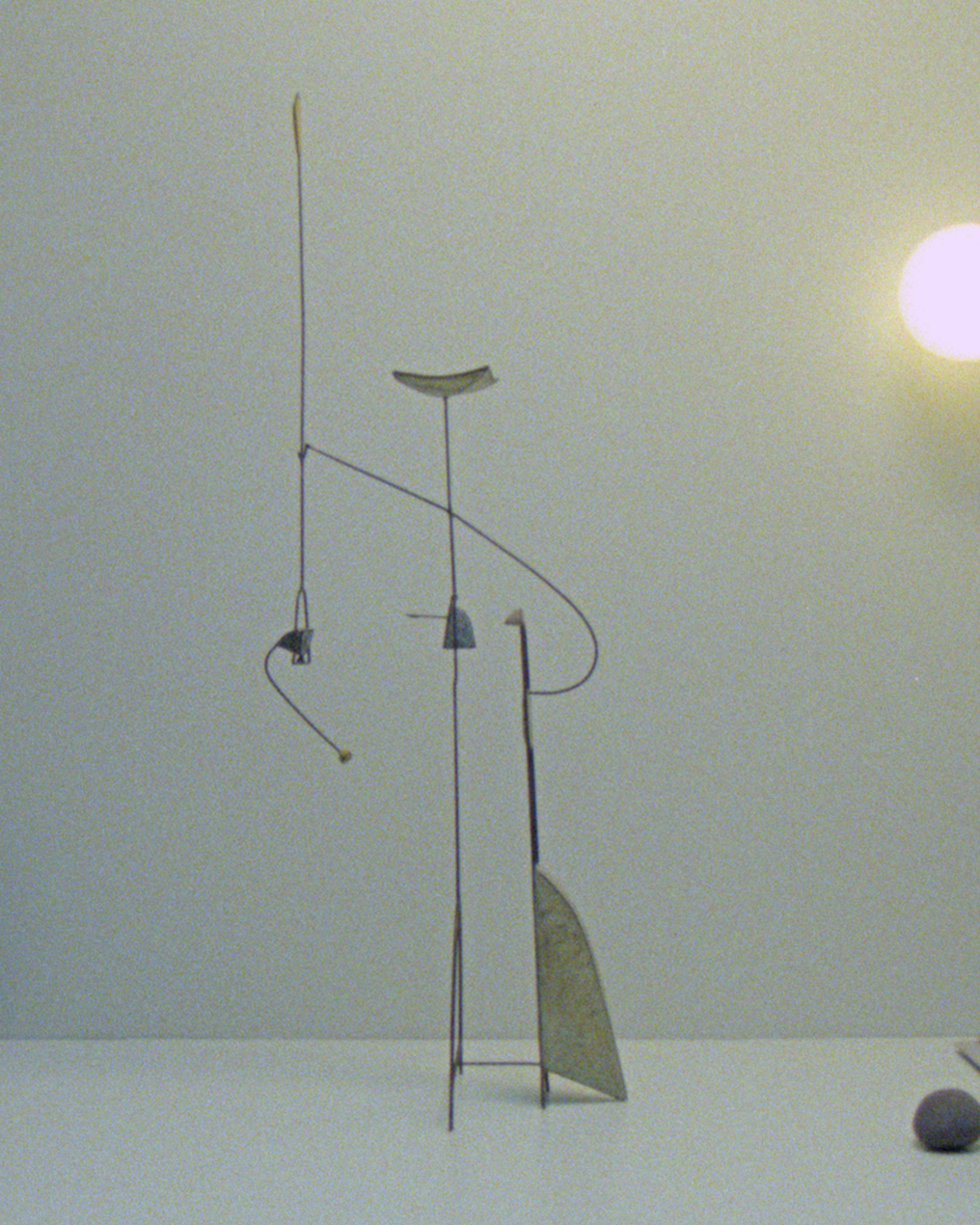 Kinetic abstract sculpture (20th century) by Thierry Dufourmantelle, shown in an interiors setting on top of a sideboard. The sculpture features four moving parts, constructed from steel and concrete with pastel yellow, turquoise, and blue pigments.