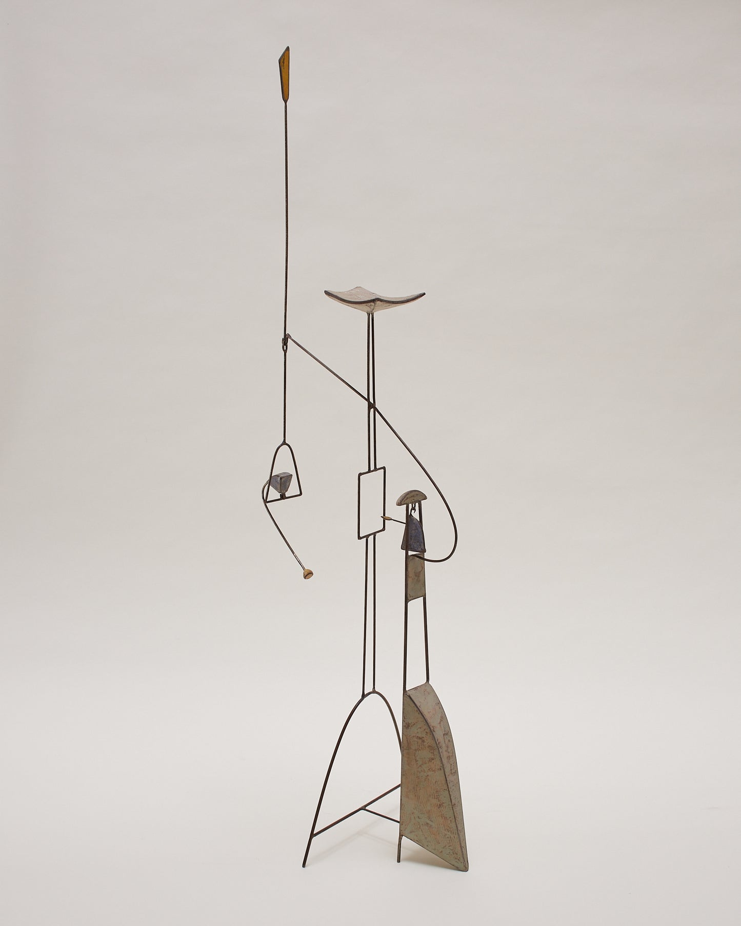Side angle view of the kinetic abstract sculpture (20th century) by Thierry Dufourmantelle, featuring four moving parts, constructed from steel and concrete with pastel yellow, turquoise, and blue pigment.