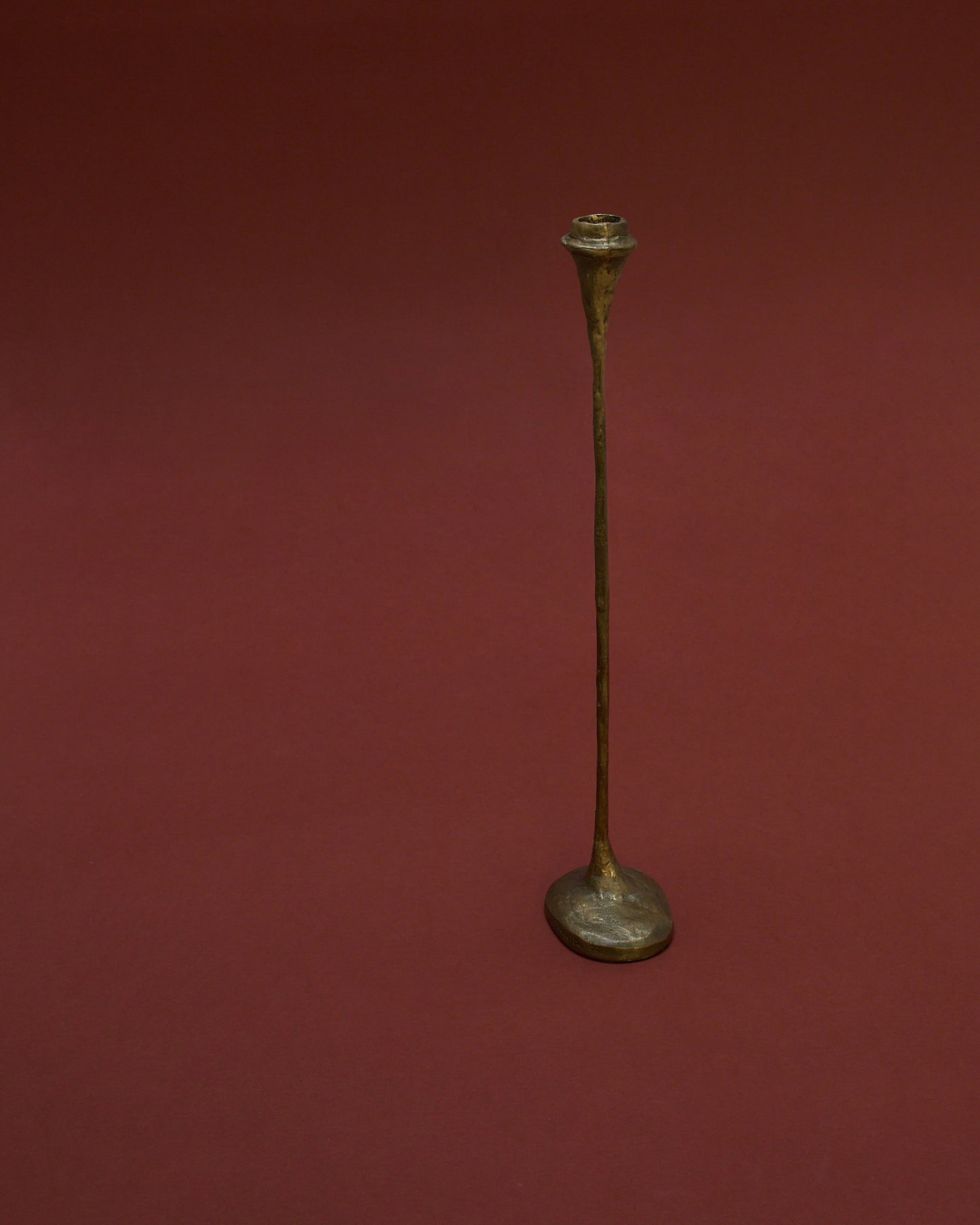 Front view of tall bronze candle holder (1980) by German sculptor Walter Kaune, featuring a sculptural design with a textured finish.