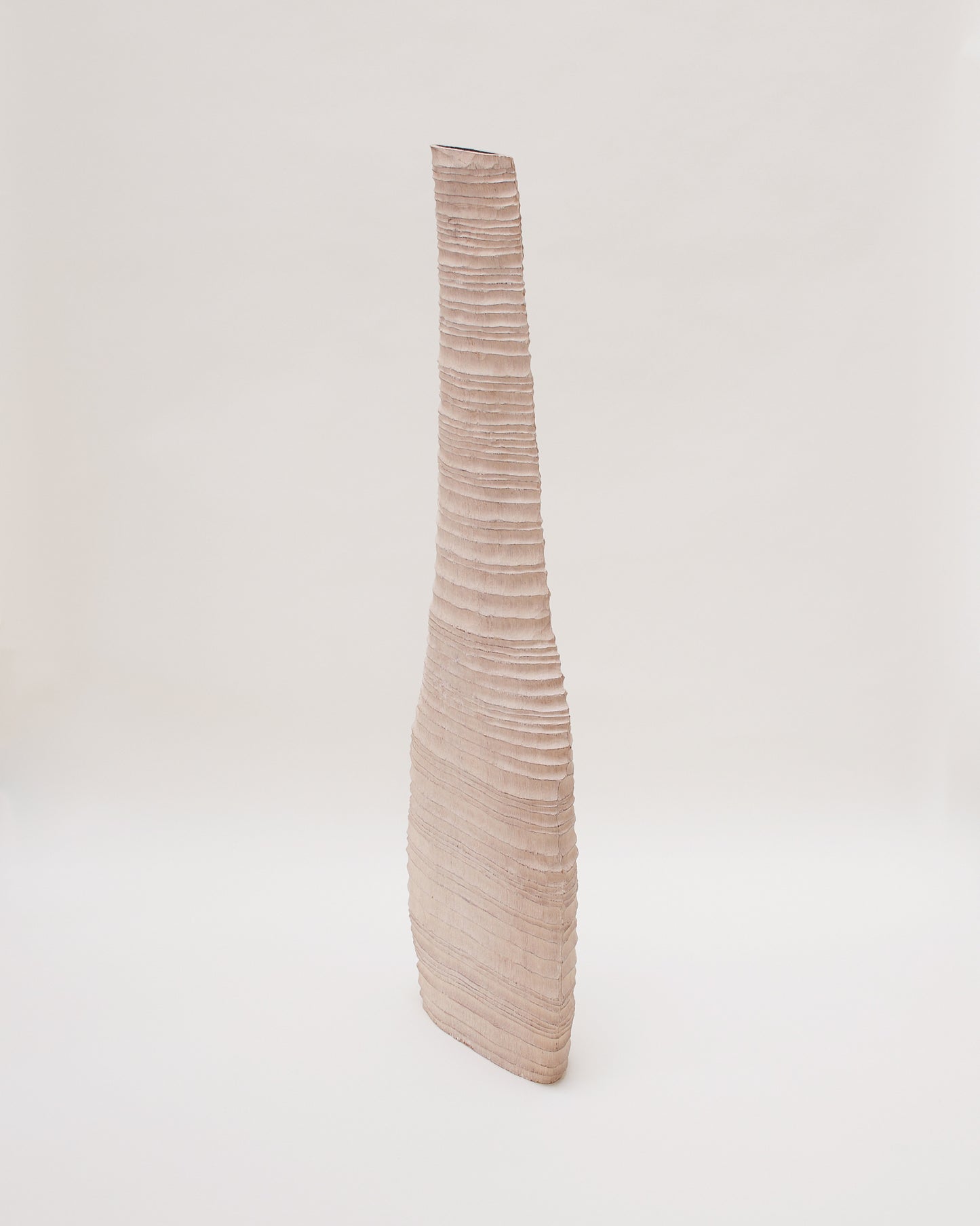 Side angle view of hand-carved oak sculpture by Malcolm Martin & Gaynor Dowling, featuring a vessel-like form with hand-tooled ridges and a limed, scorched finish.